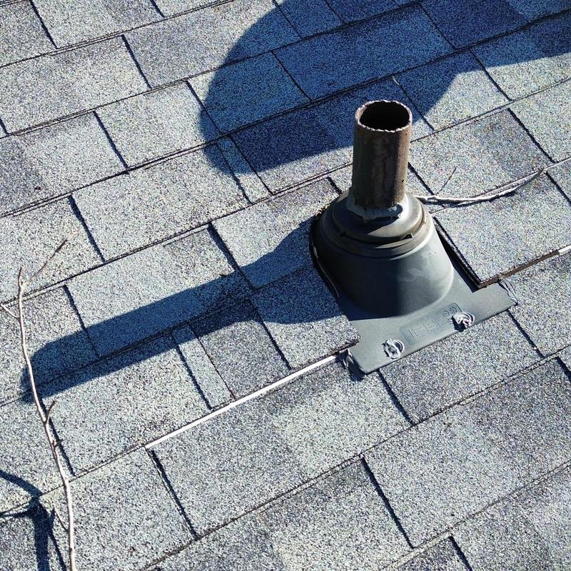 Roof vent flashing with surrounding damaged shingles