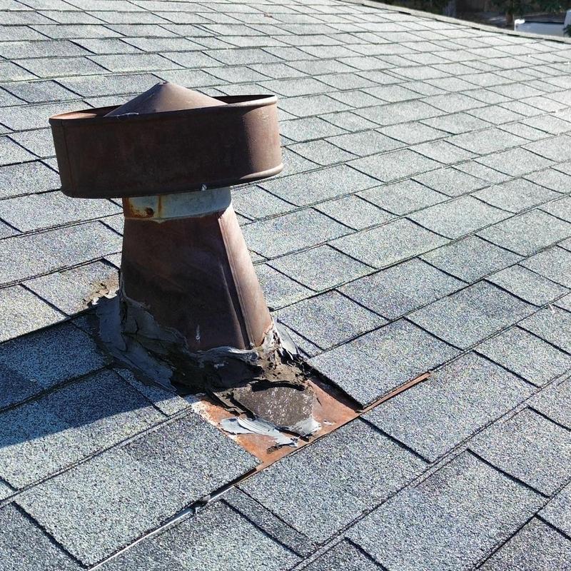 Roof vent pipe flashing with sealant on asphalt shingles