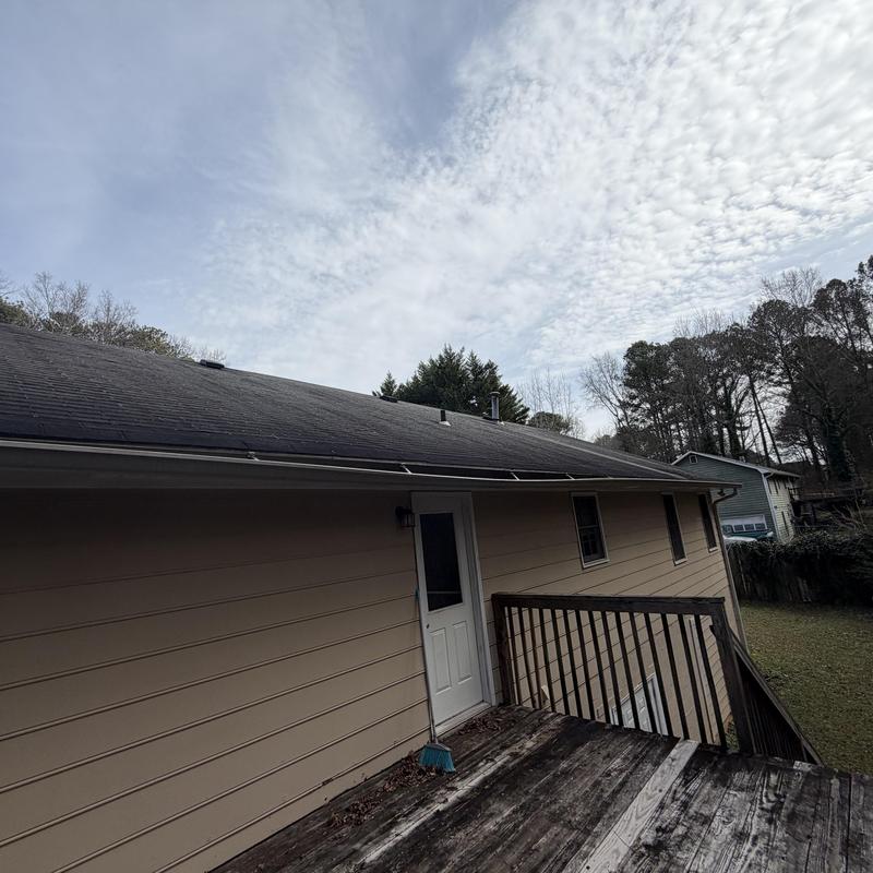 Roof shingles inspection with missing shingles and detached gutter