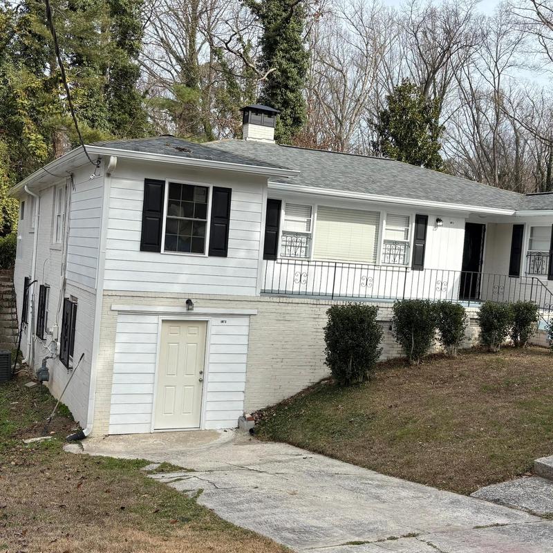 Seamless gutters and downspouts on white house exterior