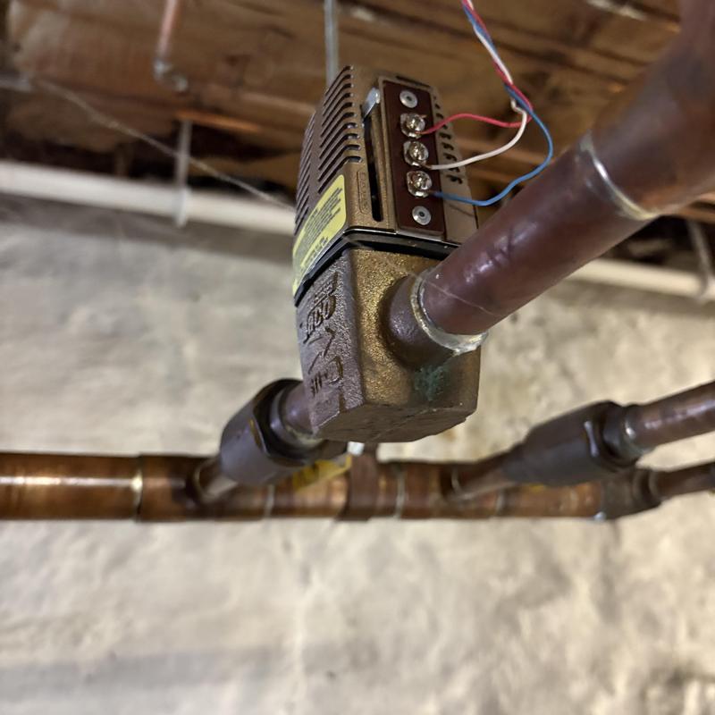 Zone valve on copper heating pipes in basement