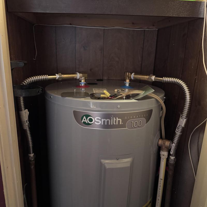 Water heater with flexible water line connections
