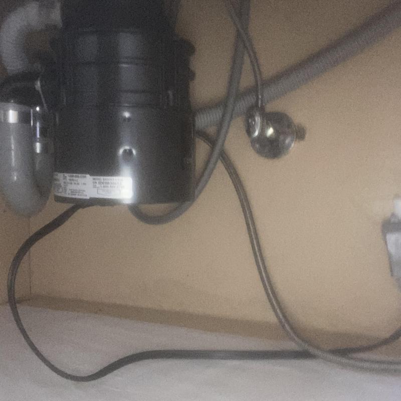 Garbage disposal unit under sink with plumbing connections