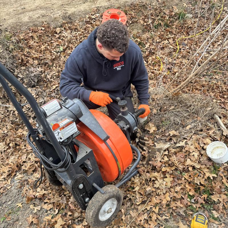 Cleanout pipe with sewer machine in yard repair