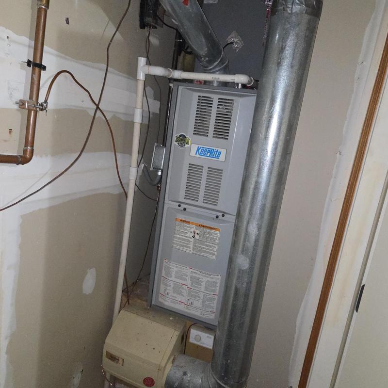 Keeprite gas furnace with vent pipes in utility room Keeprite gas furnace with vent pipes in utility room