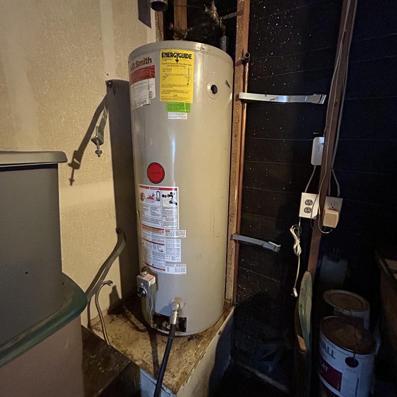 Water heater tank in basement utility area