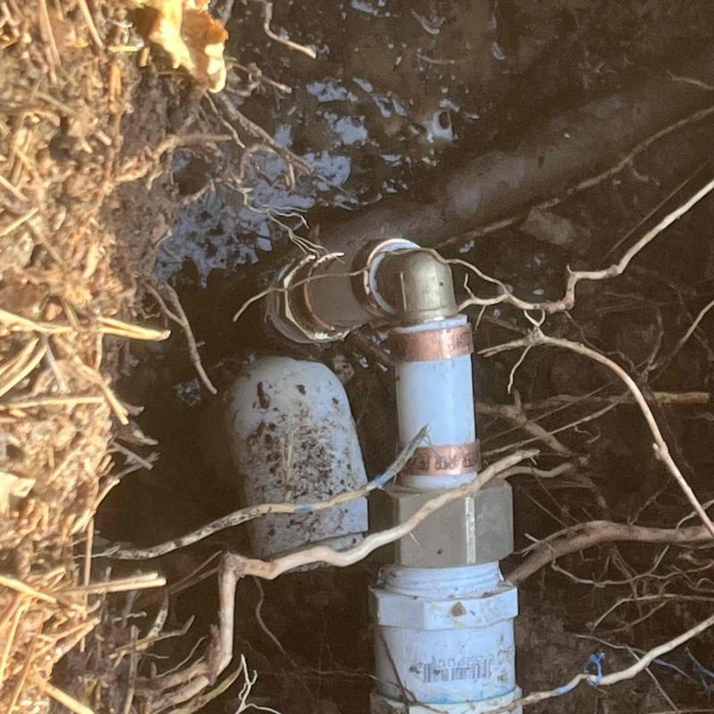 Underground pipe elbow fitting and leak repair in yard Underground pipe elbow fitting and leak repair in yard