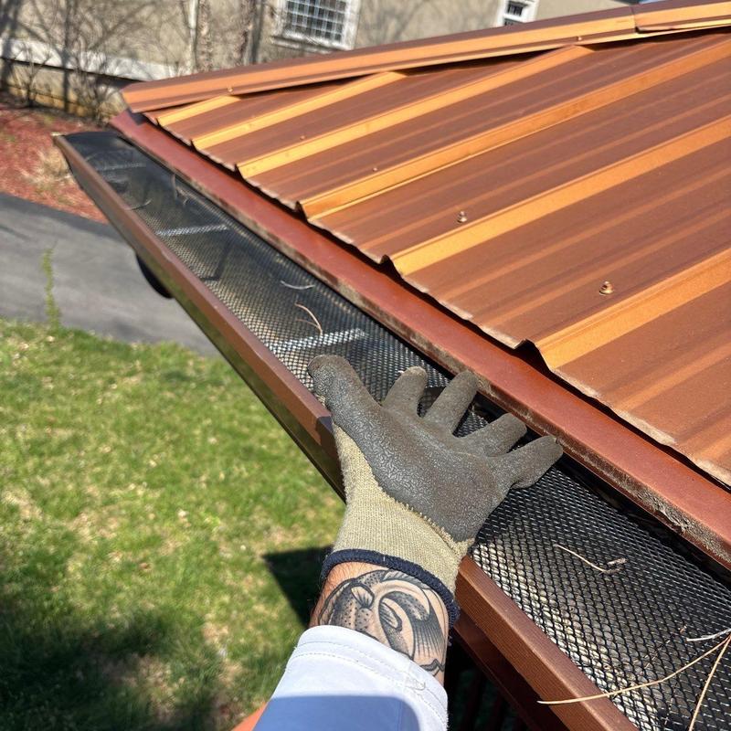 Metal roof edge with gutter guard installation check