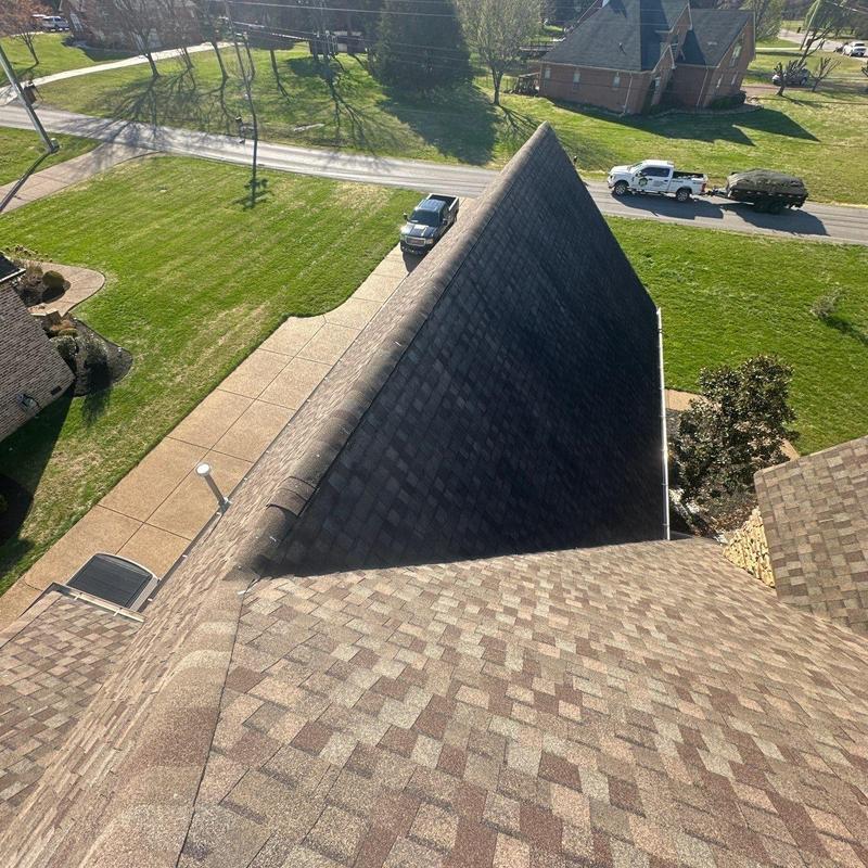 Asphalt shingle roof ridge inspection with hail damage