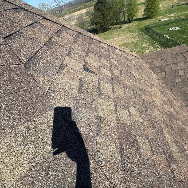 Asphalt shingles with hail damage on roof slope