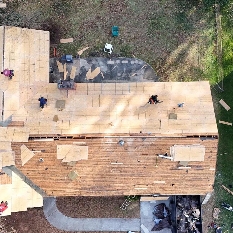 Roof decking boards and plywood installation in progress