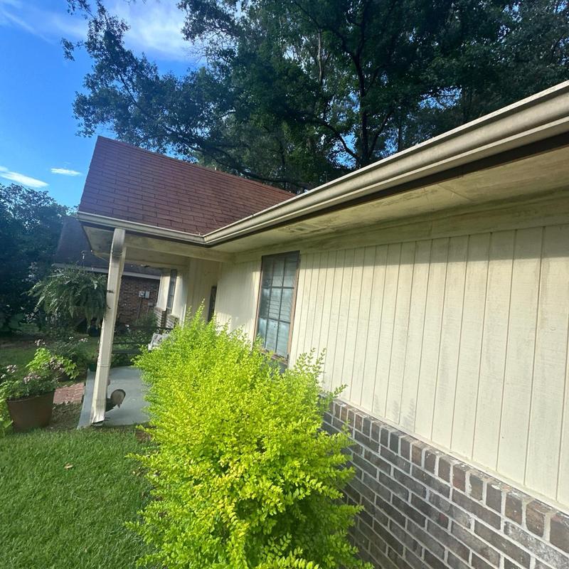Roof gutter with debris buildup on residential home