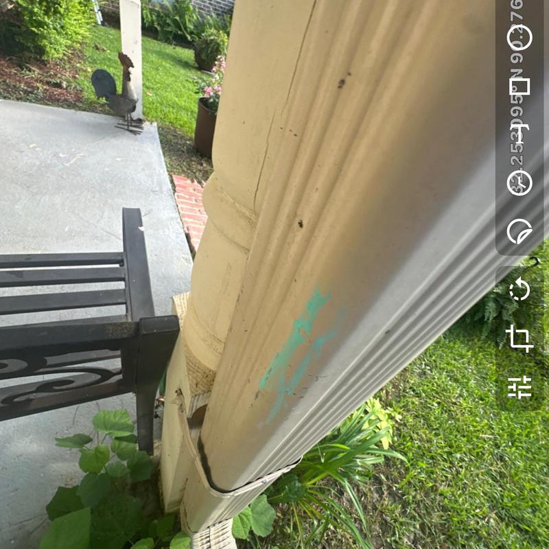 Gutter downspout with visible cracks and damage