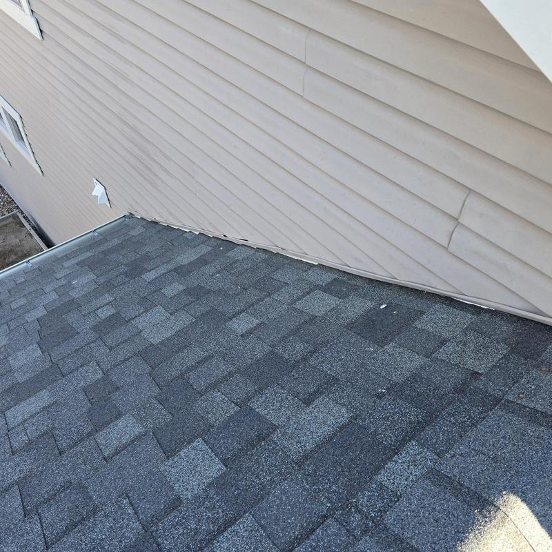 Vinyl siding J-channel reattached above asphalt shingle roof Vinyl siding J-channel reattached above asphalt shingle roof