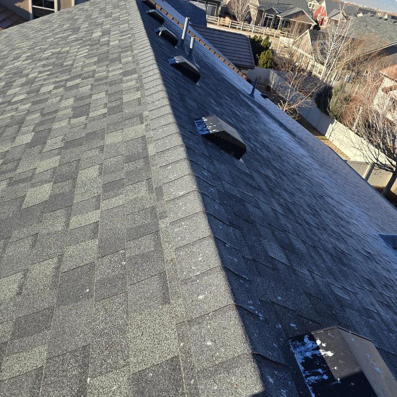 Asphalt shingle roof with vent pipes and ridge cap Asphalt shingle roof with vent pipes and ridge cap