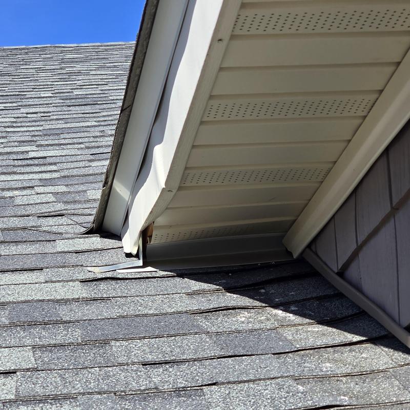 Vinyl siding J-channel reattached near roof edge Vinyl siding J-channel reattached near roof edge