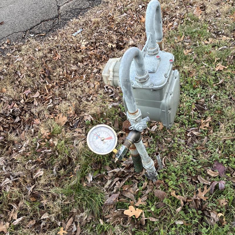 Gas meter with pressure gauge on grassy area