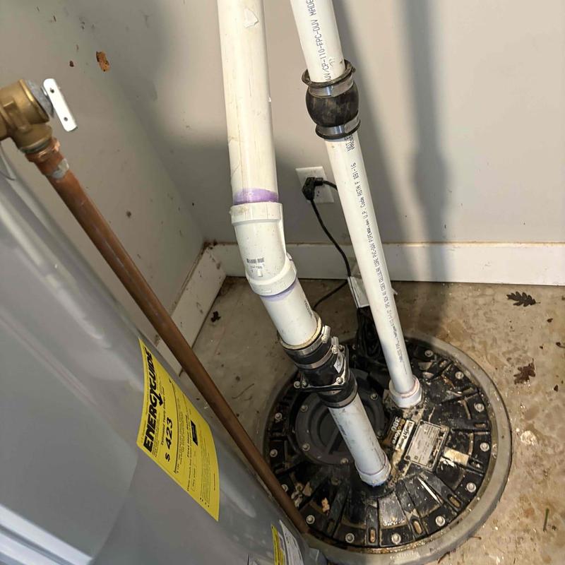 Grinder pump with connected PVC piping and fittings