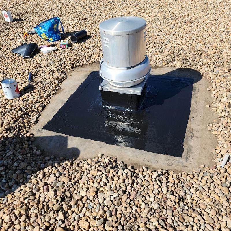 Roof pipe jack sealed with black silicone on ballast roof Roof pipe jack sealed with black silicone on ballast roof