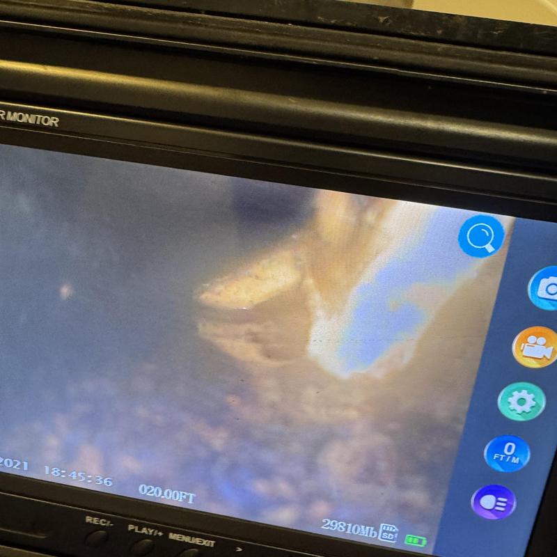 Sewer pipe inspection showing lodged toy object