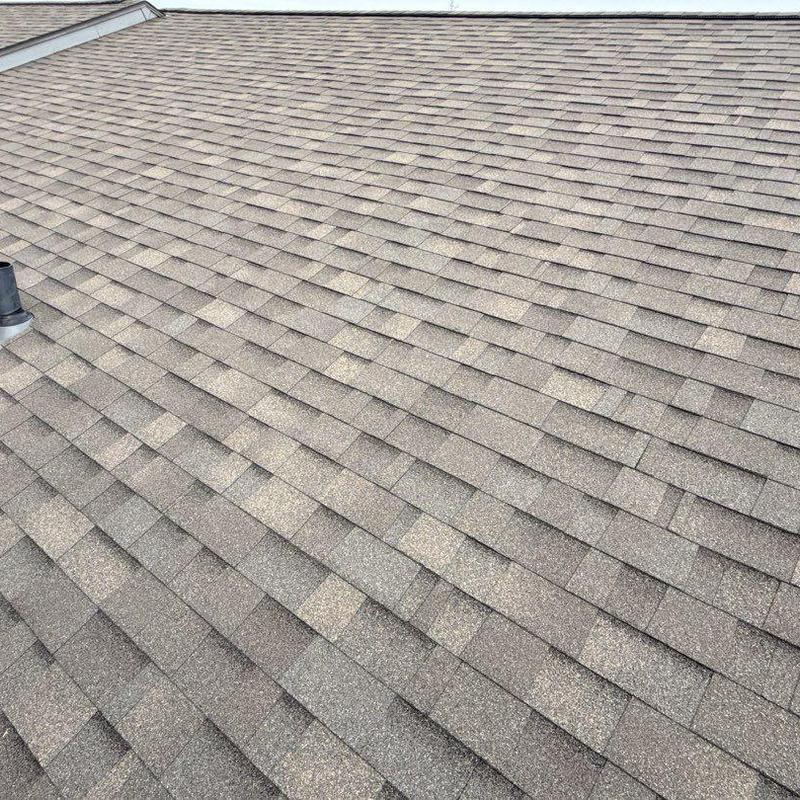 Architectural shingles on residential roof in Weathered Wood