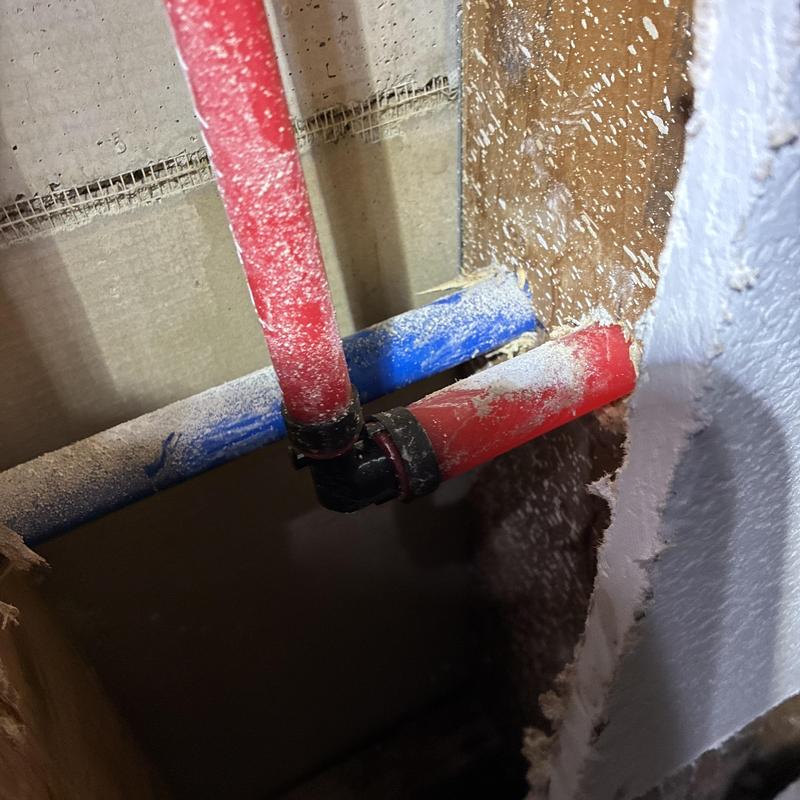 Hot water supply line with crimped fittings inside wall cavity