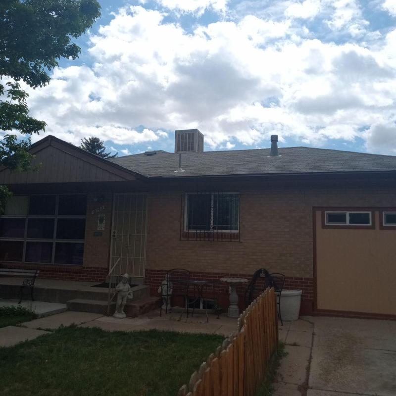 Shingle roof aging with visible wear on residential home Shingle roof aging with visible wear on residential home