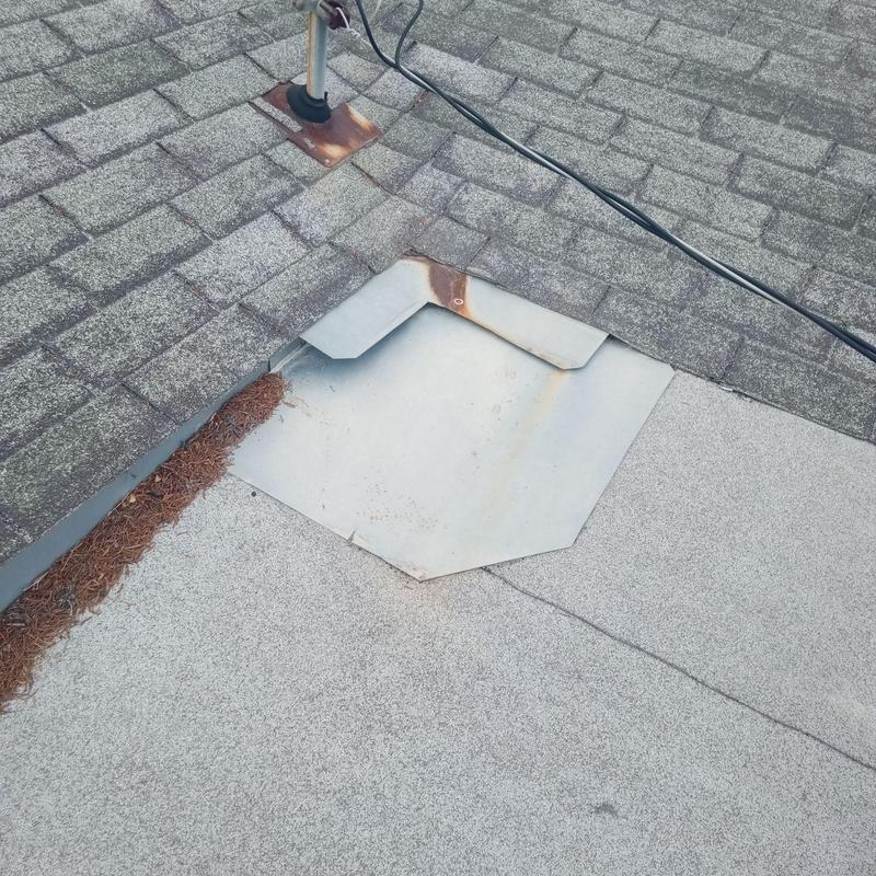 Metal flashing overlap on aging shingle roof section Metal flashing overlap on aging shingle roof section