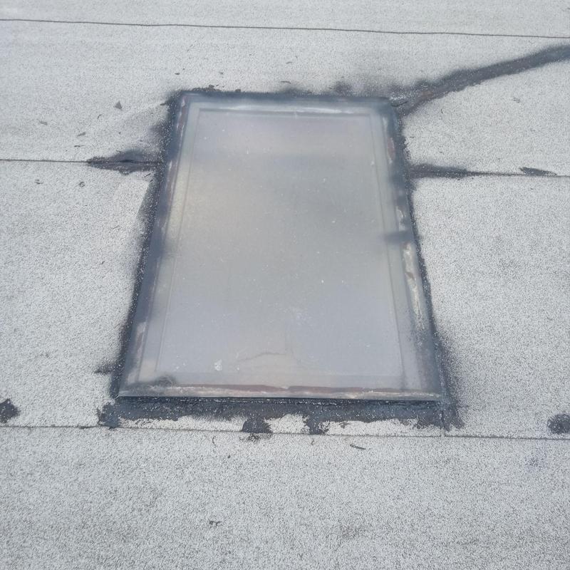 Skylight on flat roof with patched sealant Skylight on flat roof with patched sealant