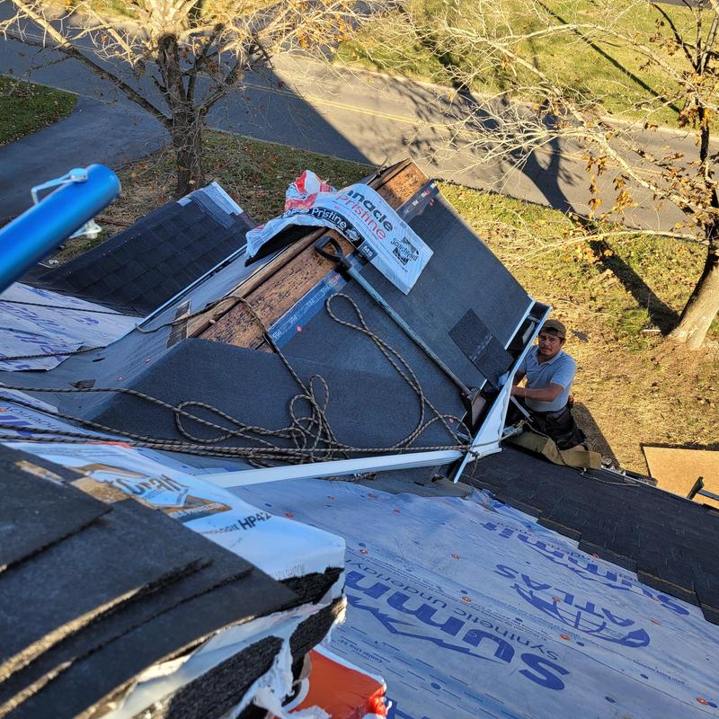 Roof shingles and underlayment installation with worker