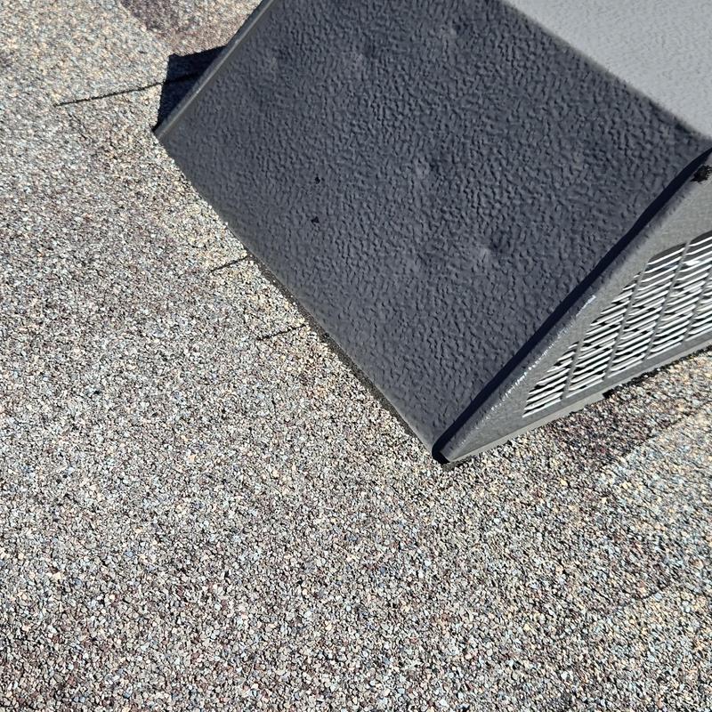 Asphalt shingle roof with hail damage near vent cover