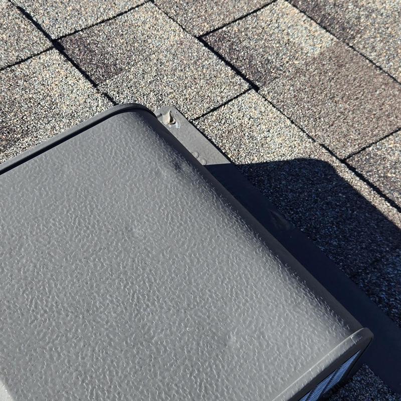 Roof vent with hail damage on asphalt shingles