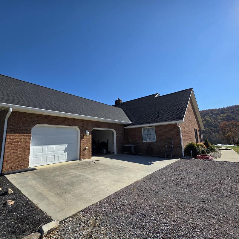 Roof replacement and gutter installation on custom brick house