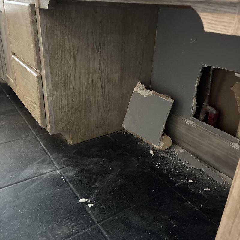 Cold water supply line behind bathroom vanity wall cutout