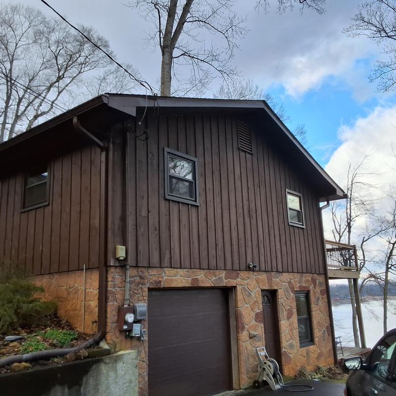Wood shingle roof on two-story lakeside home