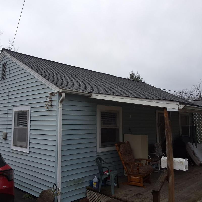 Asphalt shingle roof on blue siding house