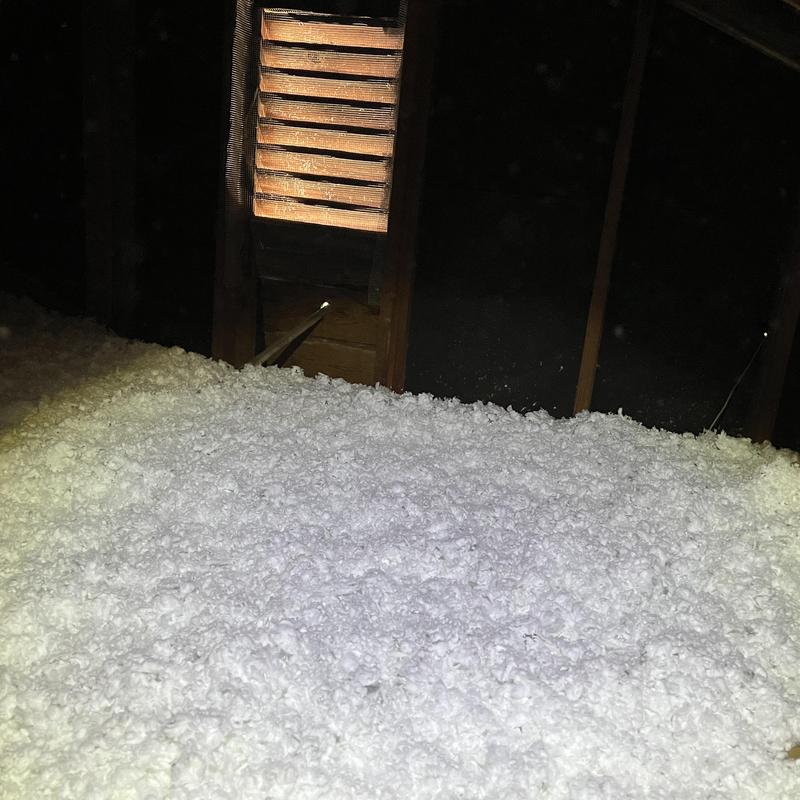 Attic loose-fill insulation installed over floor joists