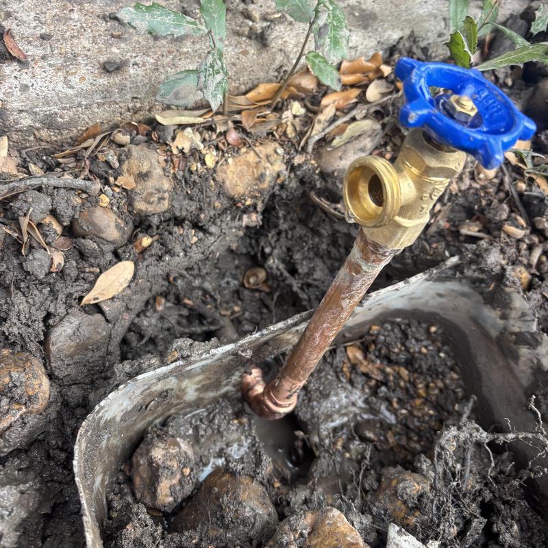 Copper hose bib valve installation in muddy ground