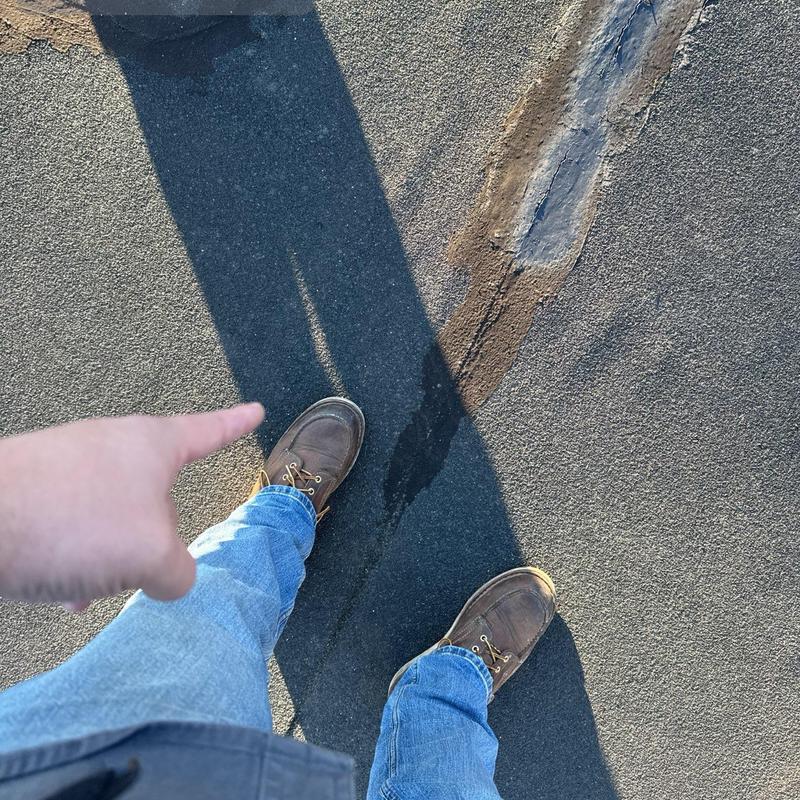 Flat roof membrane with visible seam damage and wear