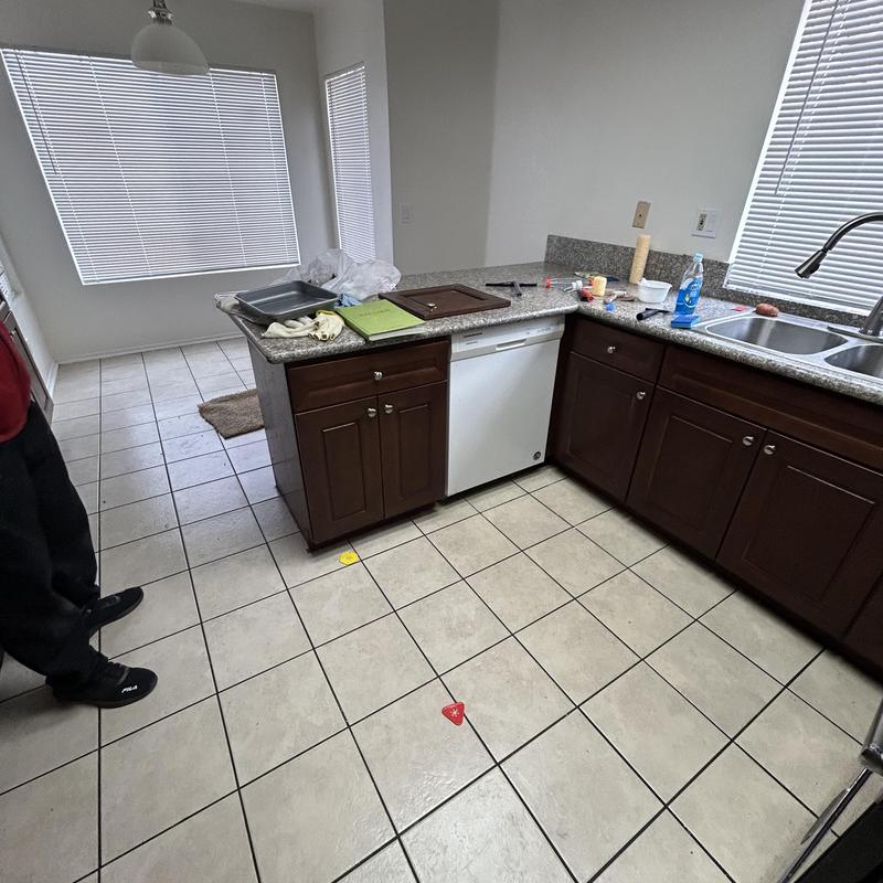Kitchen tile floor with small colored markers placed