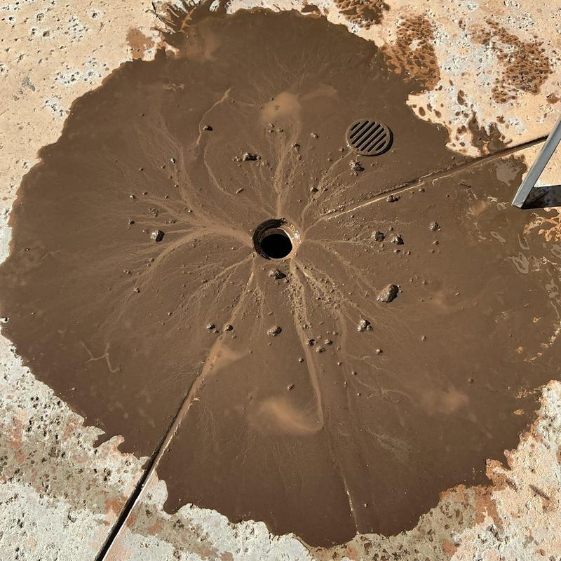 Area drain hydro jetting removing debris and roots