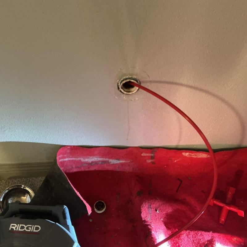 Kitchen sink drain cable snaking through wall cleanout