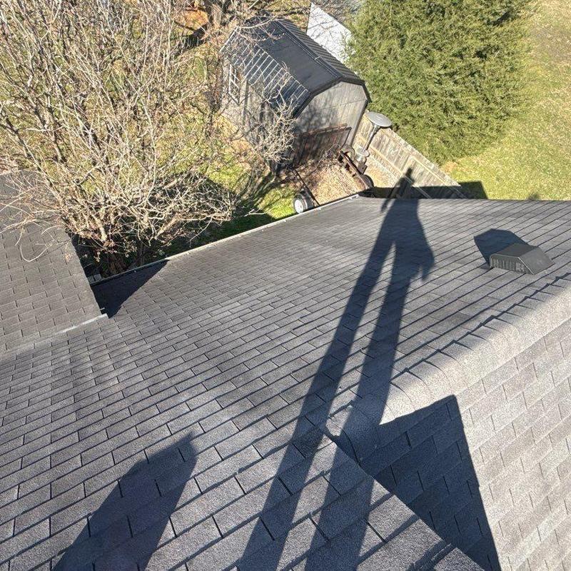 Asphalt shingle roof with ventilation pipe and shadows