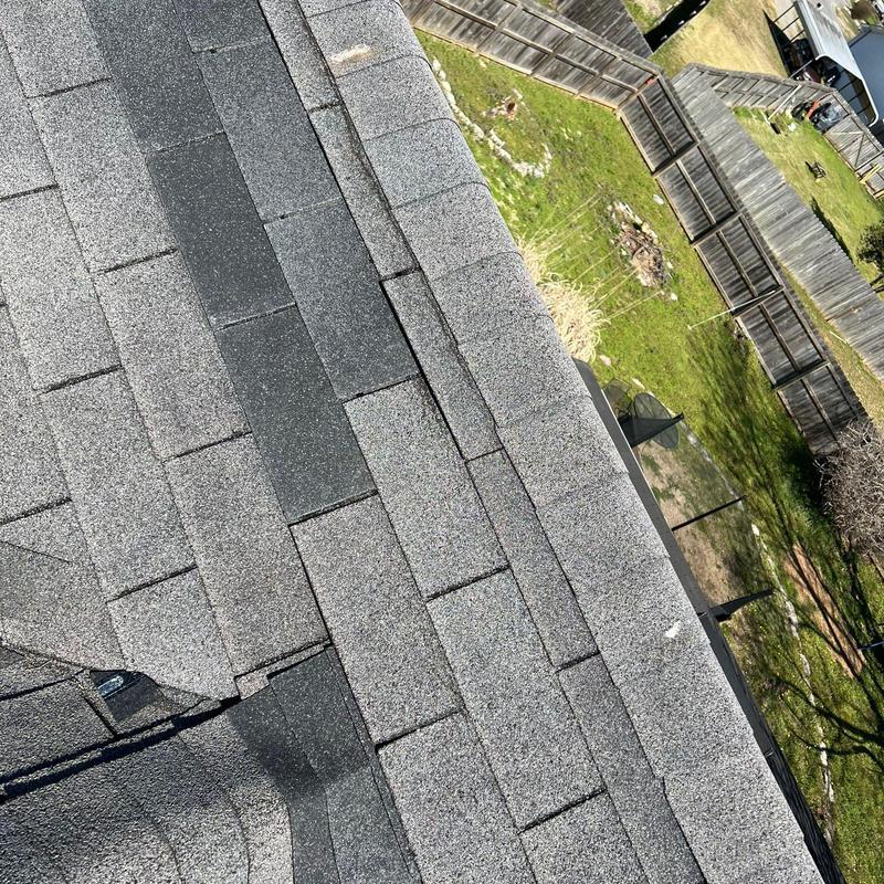 Asphalt shingle roof with hail damage and ridge cap