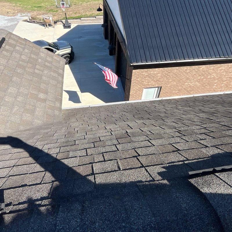 Asphalt shingles roof with hail damage and ridge caps