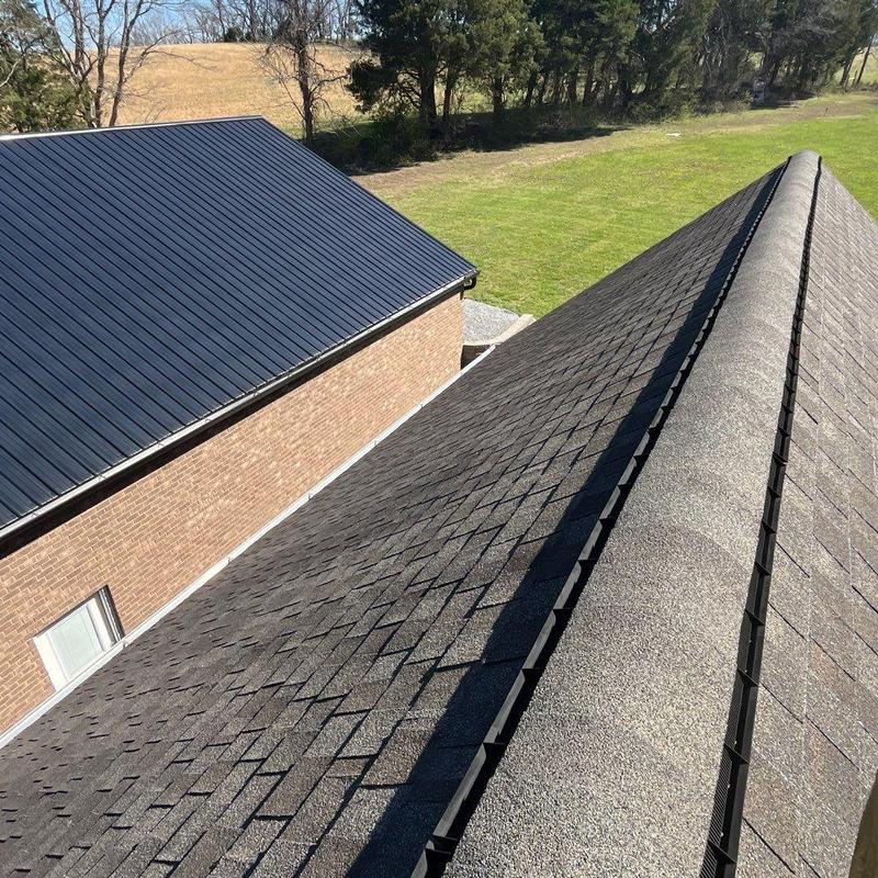 Asphalt shingle roof ridge cap with hail damage inspection