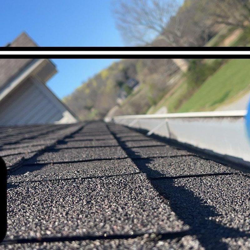Asphalt roof shingles close-up showing hail damage