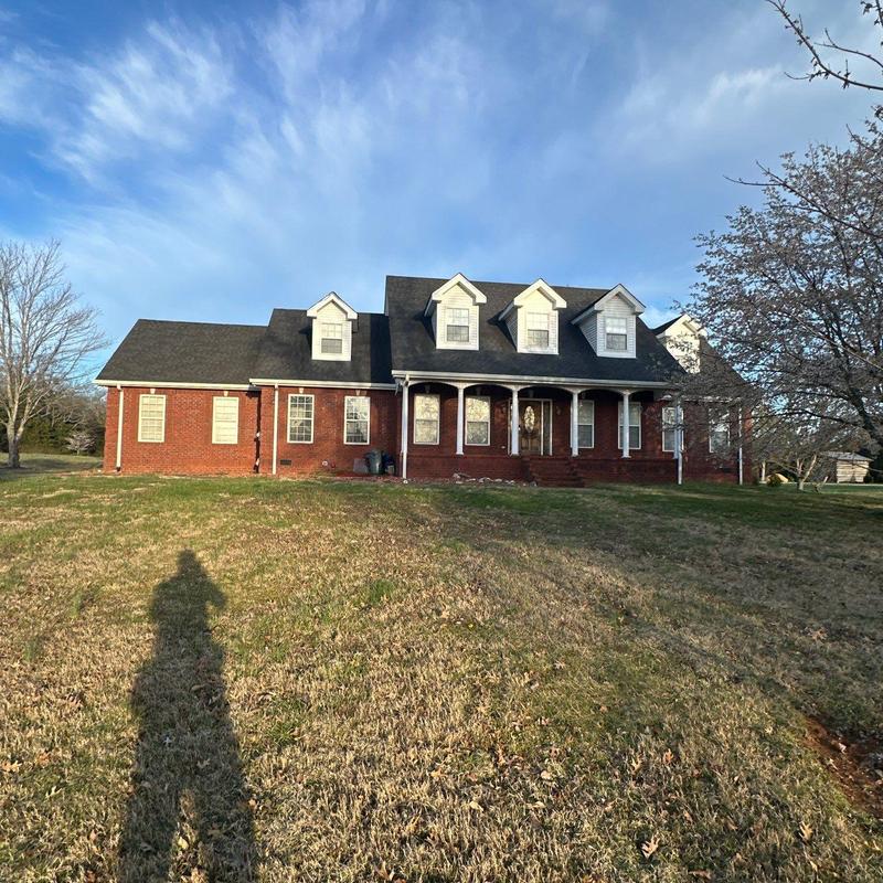 Asphalt shingle roof inspection on red brick house