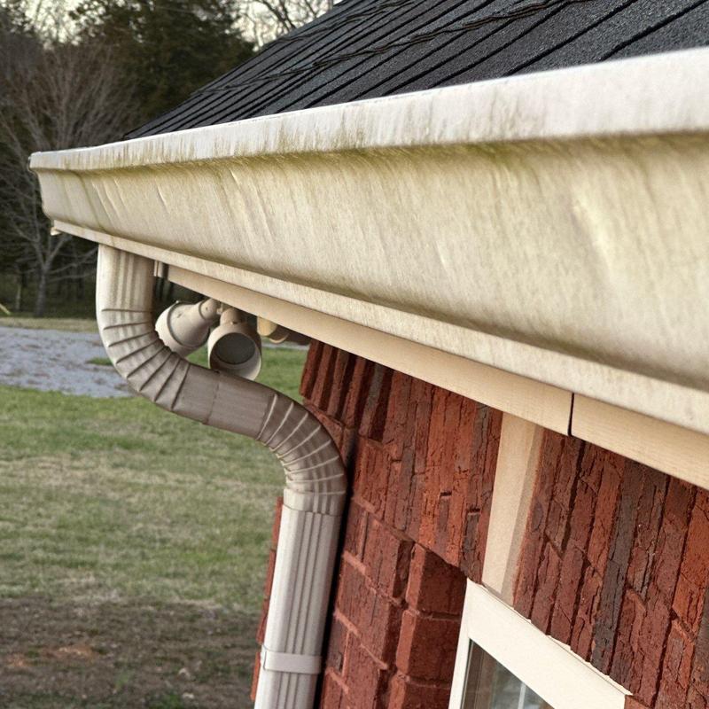 Gutter system with downspout and fascia board close-up