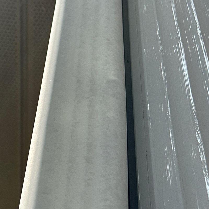 Metal flashing with wear and dents on roof edge